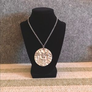 Chicos, silver tone, flat circular pendant.